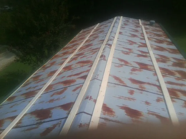 Rusted metal roof panels with new wood purlins before replacement — Storm Damage Roof Repair in Pacoima by Roofing Brothers