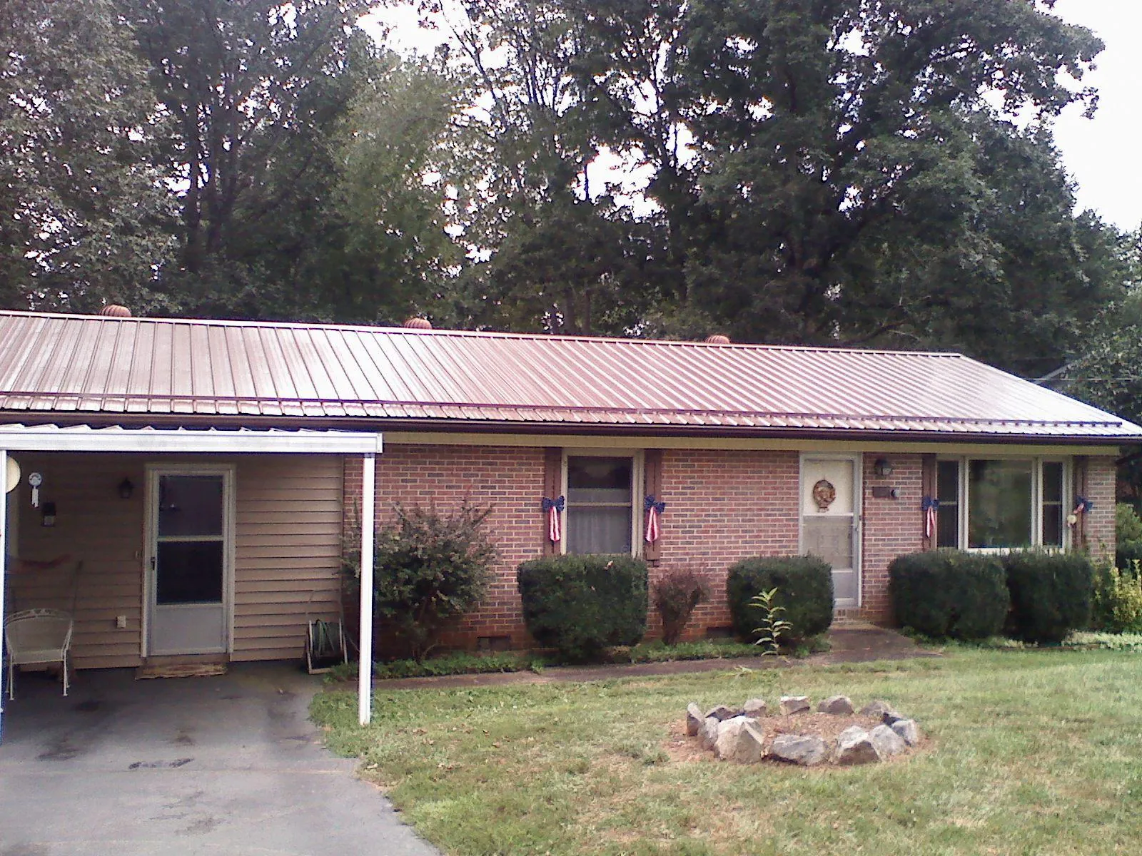 Bronze metal roof and carport on a brick ranch home — Roof Repair work by our crew in Pacoima